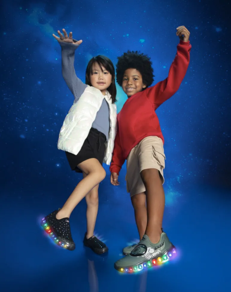 Two kids dancing in light-up trainers